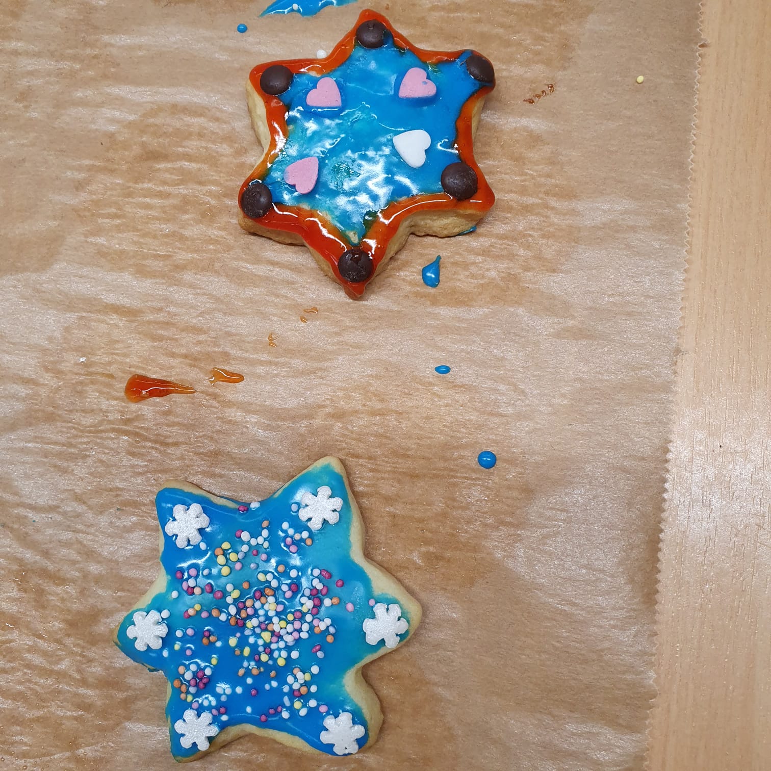 Zwei Plätzchen mit blauer Verzierung.